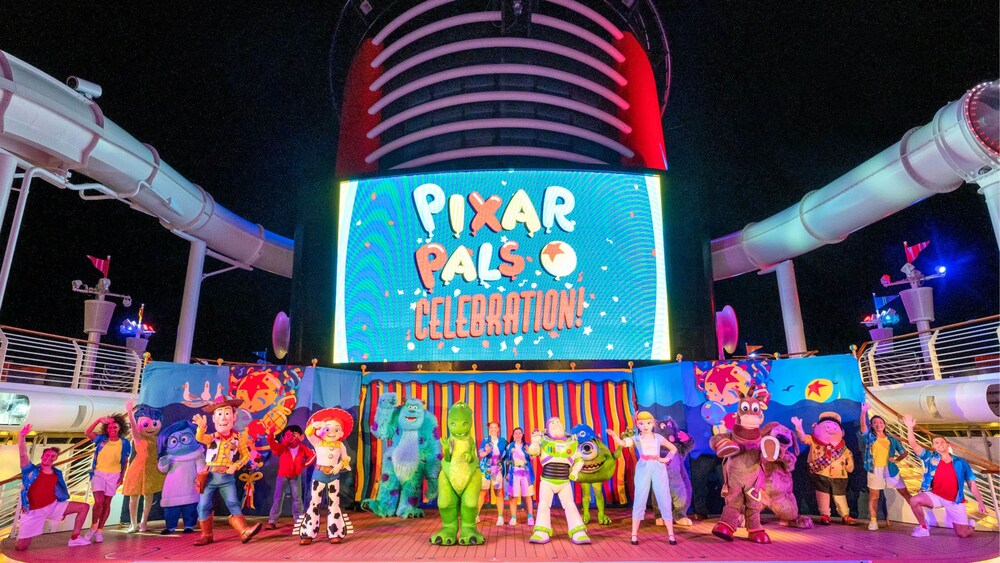 Pixar Characters waving on the deck of a Disney cruise ship with a screen that reads ‘Pixar Pals Celebration’