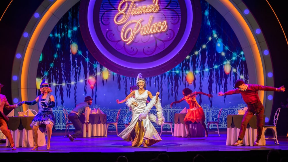 Princess Tiana sings on stage with jazz dancers at Disney Seas the Adventure, a musical