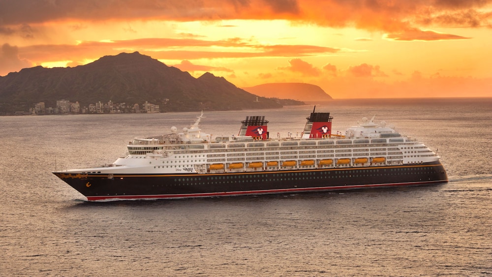A Disney Cruise Line ship sailing along a coastline