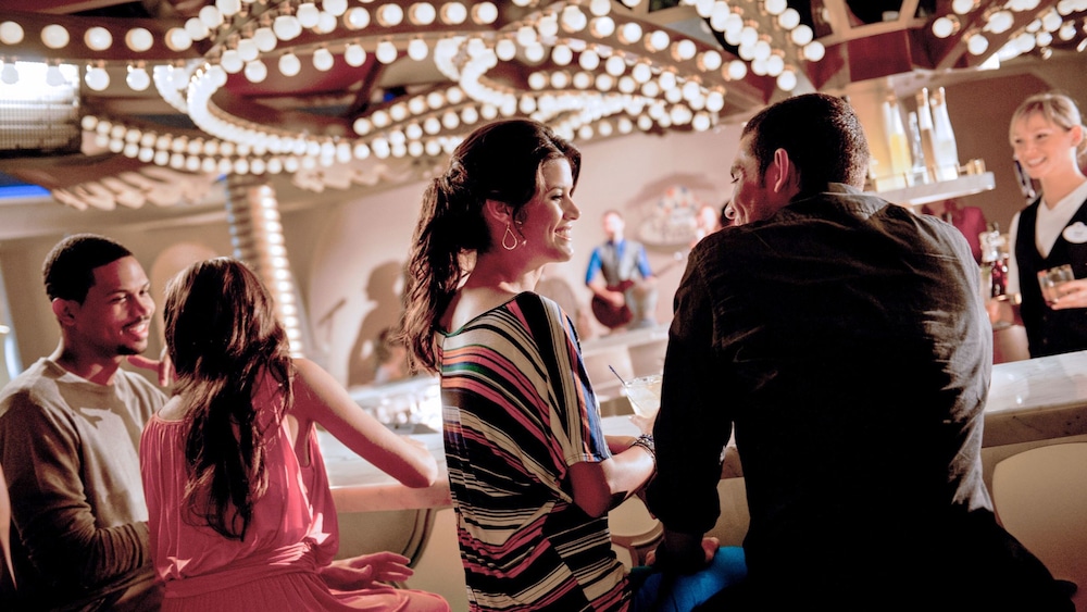 Two couples chatting while waiting for a drink at La Piazza, a bar