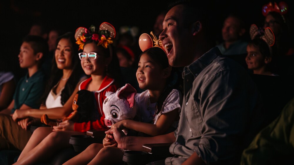 Guests laughing and smiling in an audience
