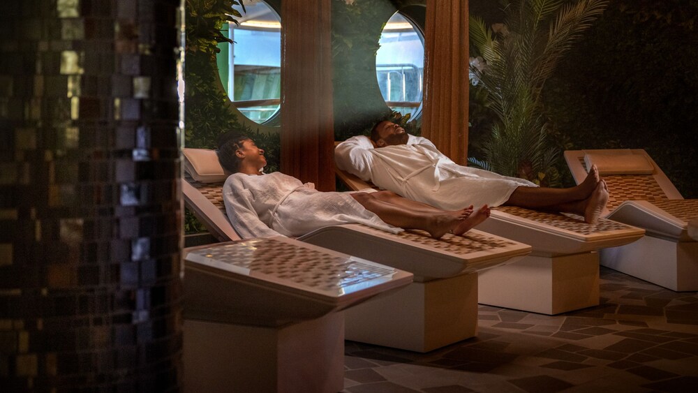 Guests relaxing on thermal lounge chairs at a spa on a Disney cruise ship