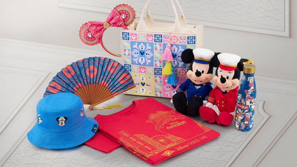 A selection of Disney Adventure merchandise including a fan, hat, T shirt, fan, bag, water bottle, Minnie Mouse ear headband and Captain Mickey Mouse and Captain Minnie Mouse plushes