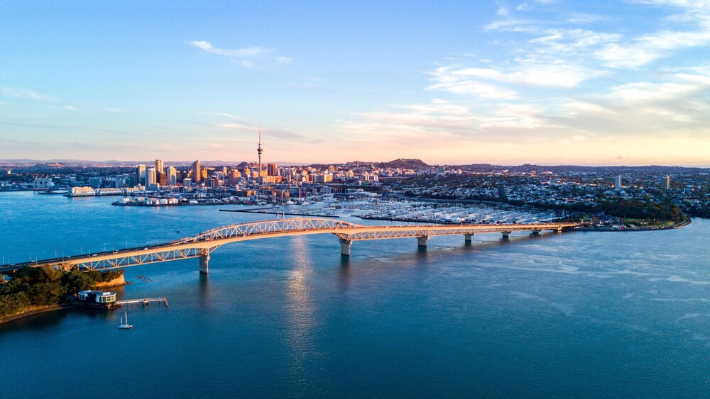 A long bridge spanning across a harbor to a cosmopolitan city