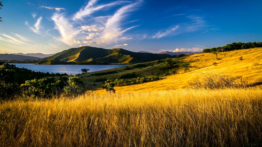 Rolling hills and mountains surrounding a body of water