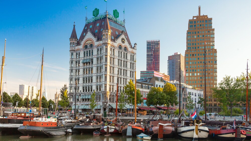 Several boats docked in front of White House in Rotterdam, Netherlands
