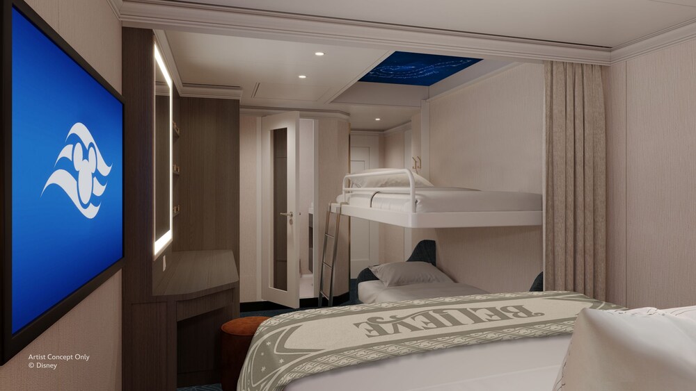 An Inside stateroom on the Disney Believe cruise ship, featuring a bed next to 2 bunk beds with decorative stars on the ceiling