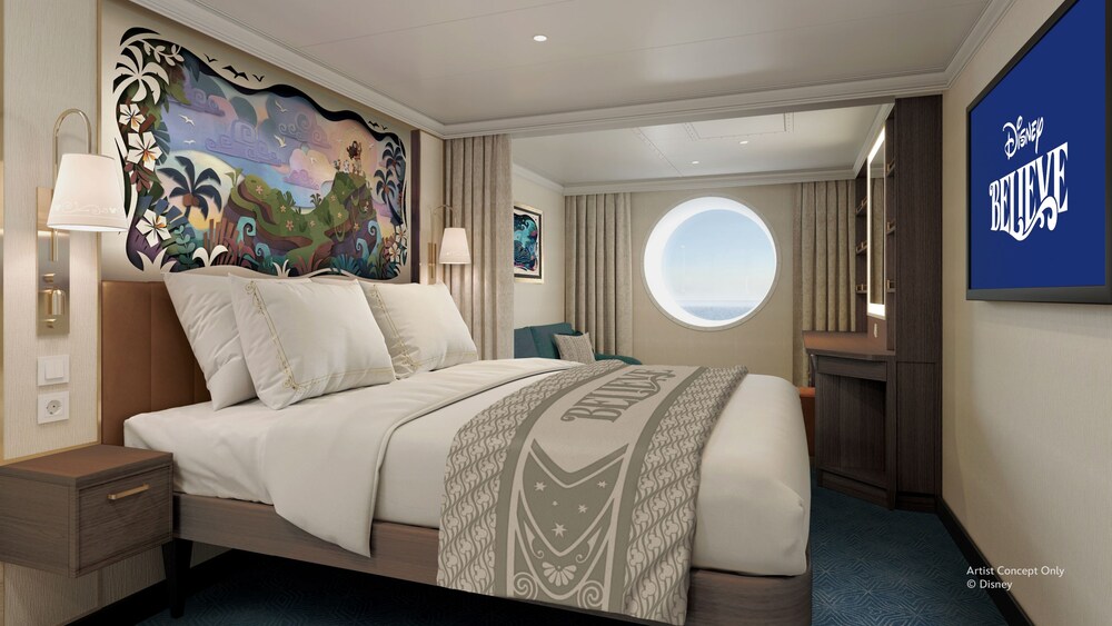 An Oceanview stateroom on the Disney Believe cruise ship, featuring a bed and sofa near a porthole