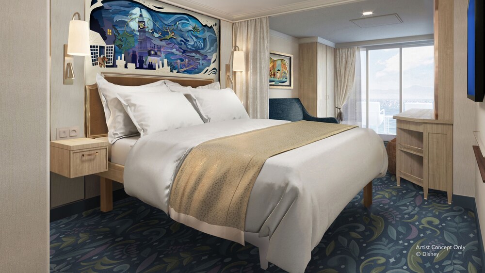 A Concierge stateroom on the Disney Believe cruise ship, featuring a bed, sofa and veranda