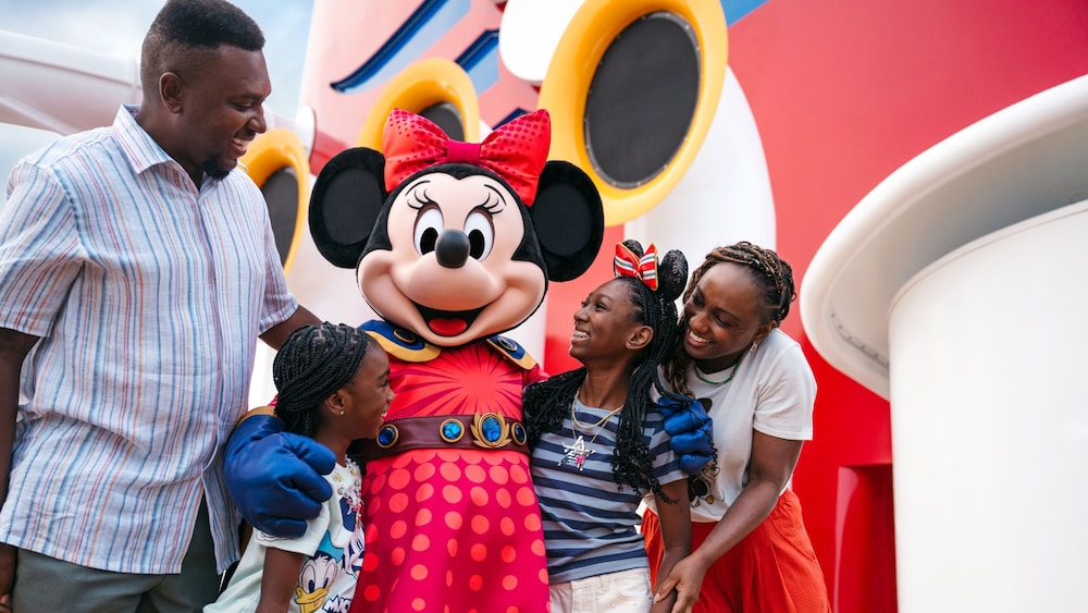 A family enjoying a Character Greeting with Minnie Mouse on board the Disney Destiny