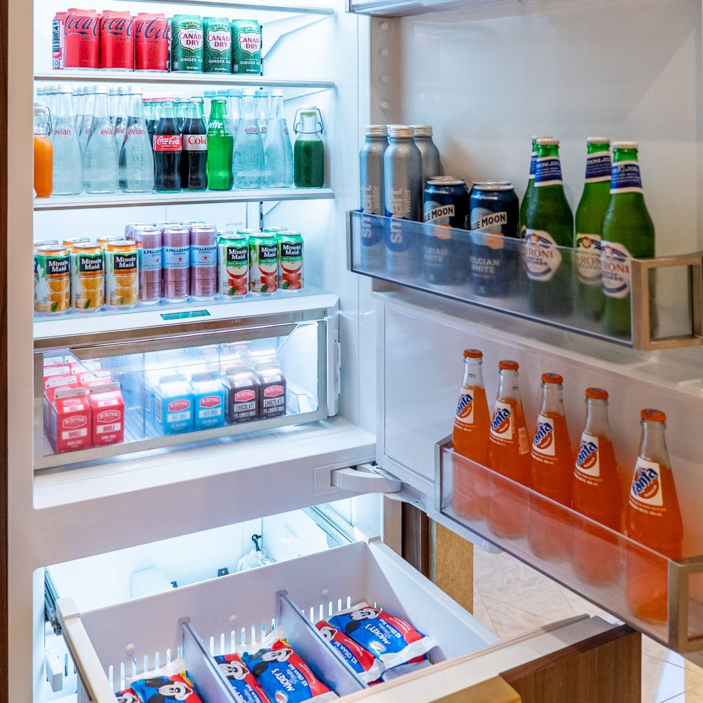 An open beverage refrigerator in a Disney Dream Concierge Dream Tower Suite