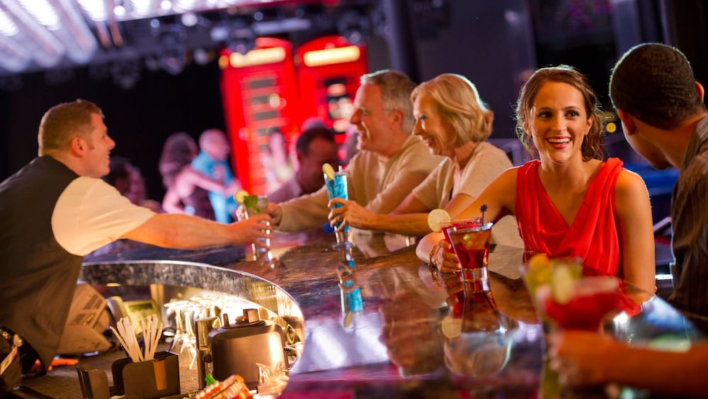 A bartender serves Guests cocktails at The Tube, a nightclub on the Disney Fantasy cruise ship 