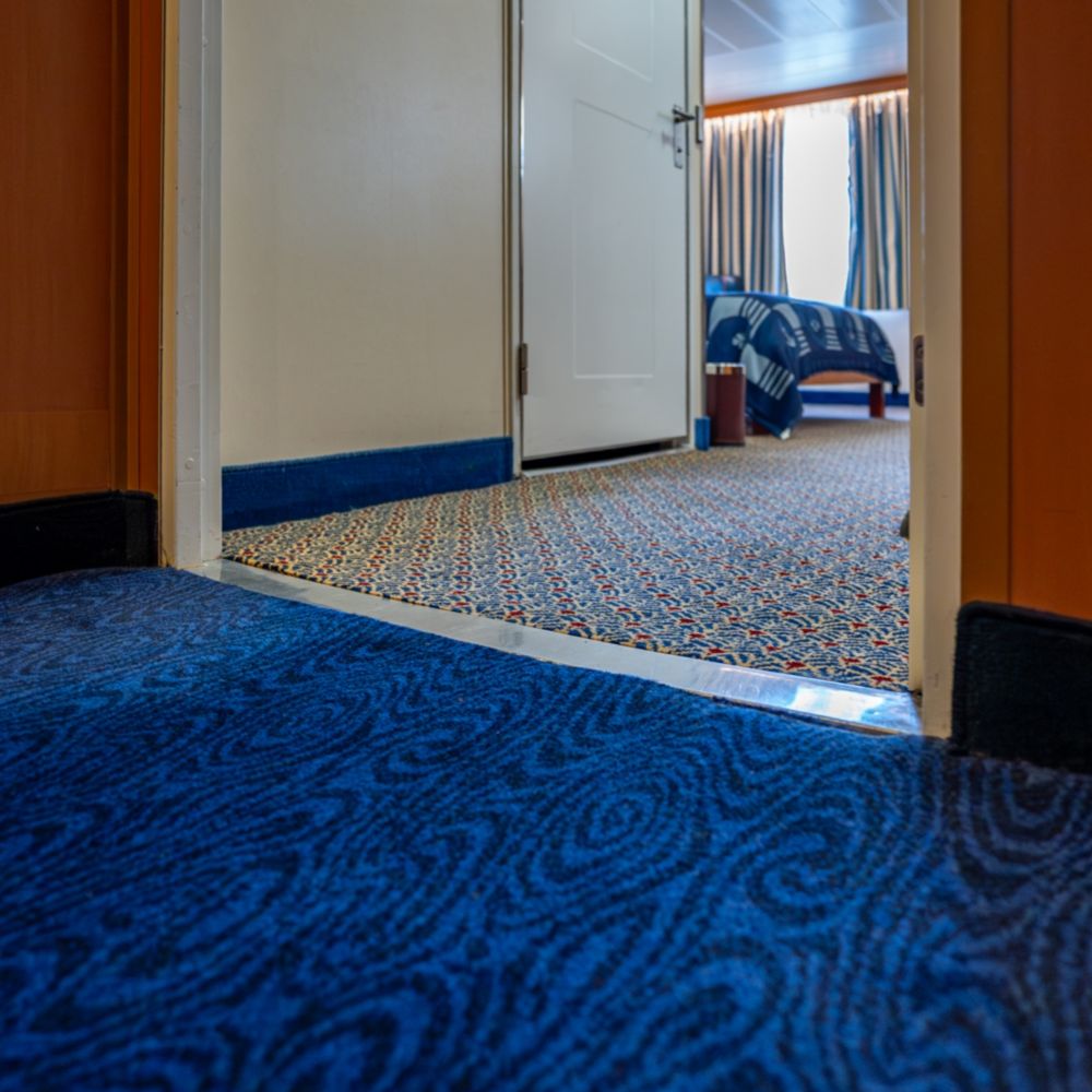A wheelchair accessible entrance to a Disney Magic Deluxe Oceanview Stateroom with Verandah