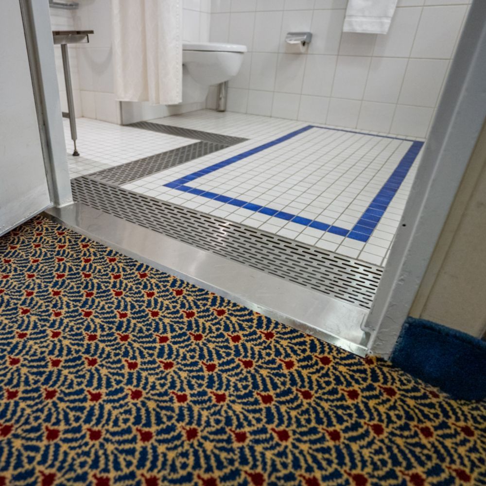 The entrance to a wheelchair accessible bathroom in a Disney Magic Deluxe Oceanview Stateroom with Verandah
