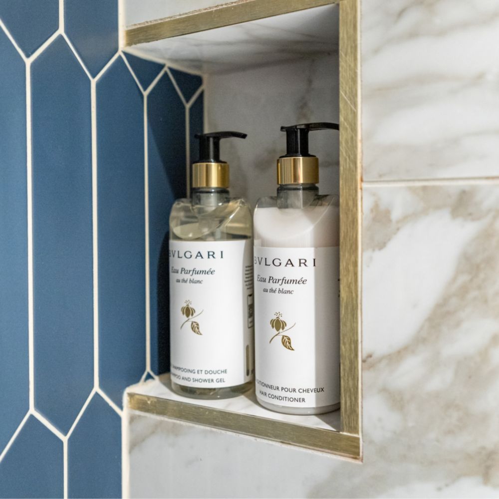 A bathroom with Bulgari shampoo & shower gel and hair conditioner in a Disney Magic Concierge 2 Bedroom Suite with Verandah