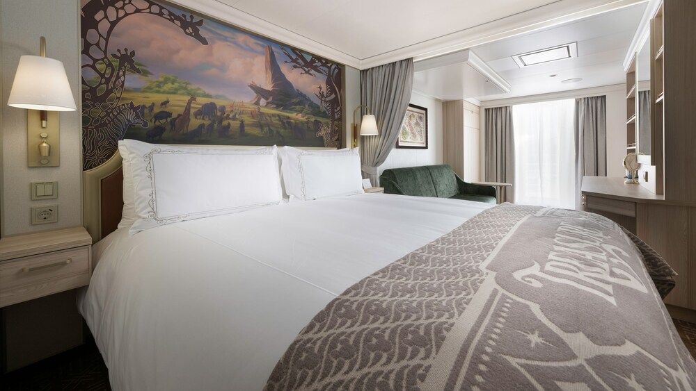 An artist rendering of a Disney Treasure Concierge Family Oceanview with Verandah Stateroom with a bed, a sofa, a vanity and a verandah with an ocean view