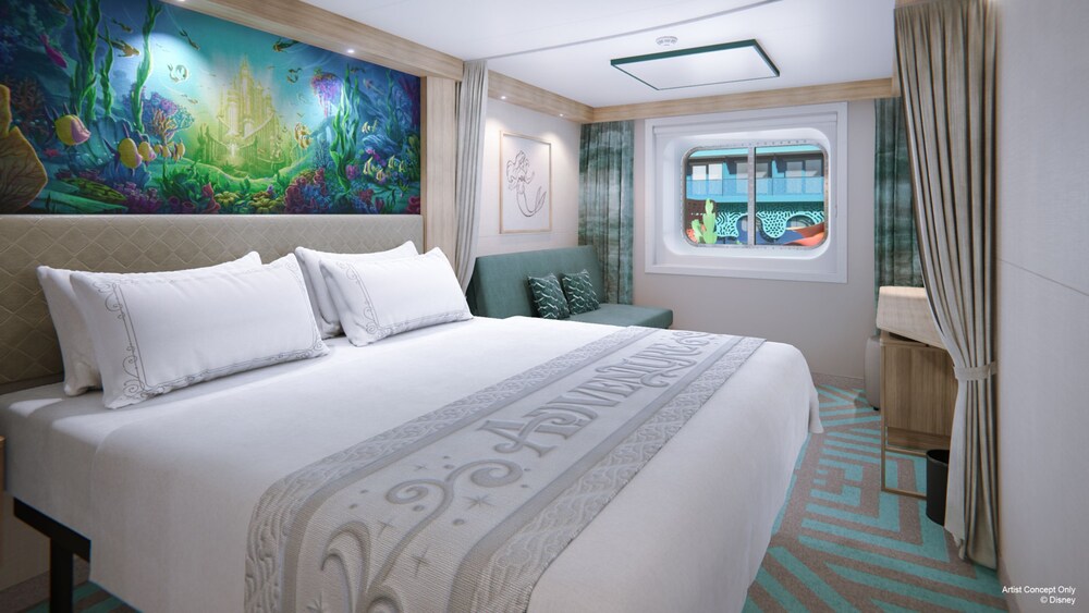 An artist rendering of a Deluxe Inside with Reef View stateroom on the Disney Adventure with a bed, sofa, artwork inspired by The Little Mermaid and a window with a reef view