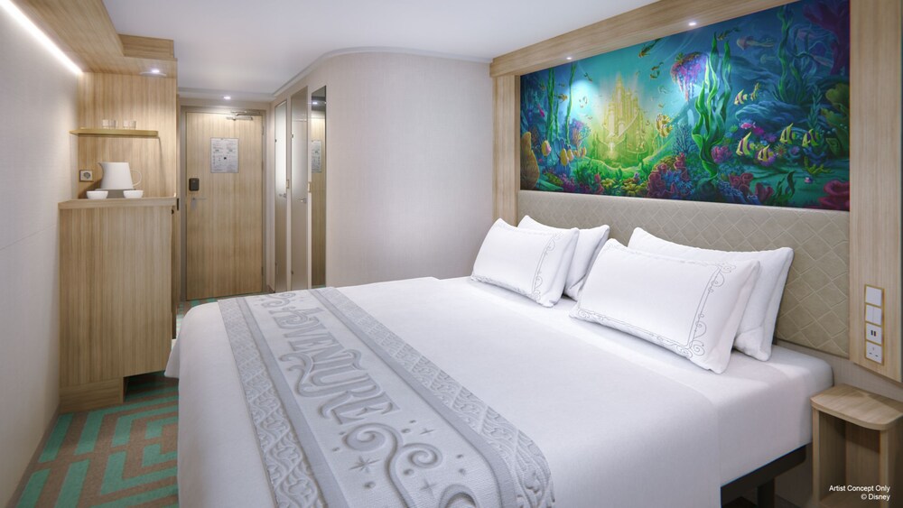An artist rendering of a Deluxe Inside with Reef View stateroom on the Disney Adventure with a bed and artwork inspired by The Little Mermaid