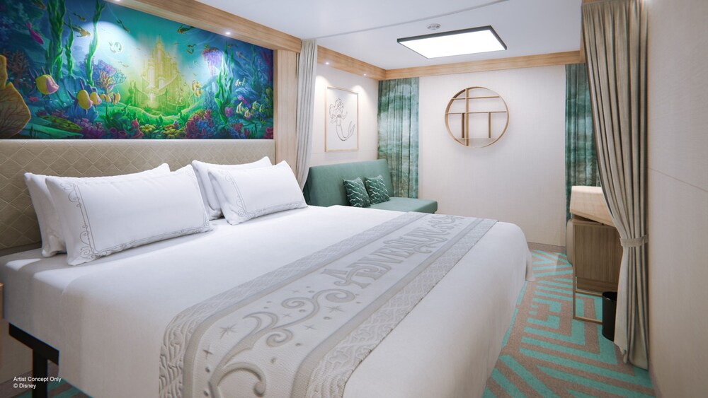 An artist rendering of a Deluxe Inside stateroom on the Disney Adventure with a bed, sofa and artwork inspired by The Little Mermaid