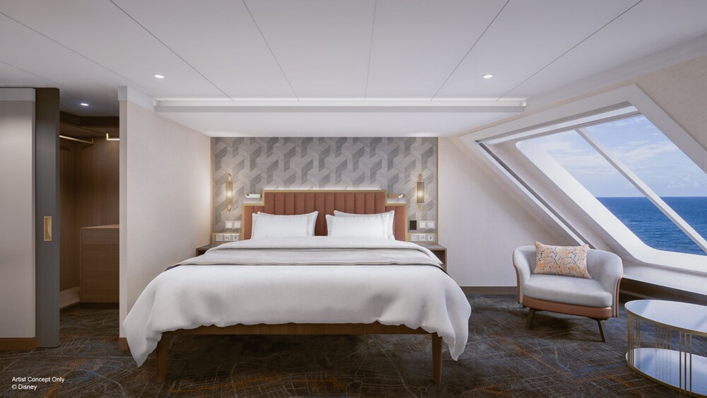 An artist rendering of a Disney Adventure Concierge Oceanview Suite bedroom with a bed, nightstands, chair, table and a large window facing the ocean