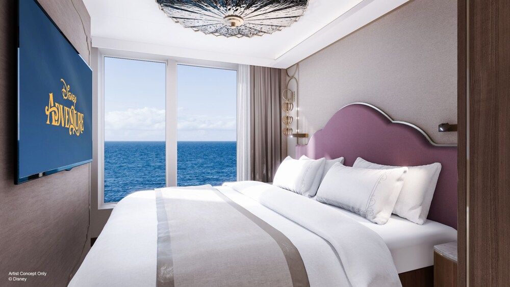 An artist rendering of a Disney Adventure Concierge Family Oceanview Suite bedroom with a bed, nightstand, TV and a window facing the ocean