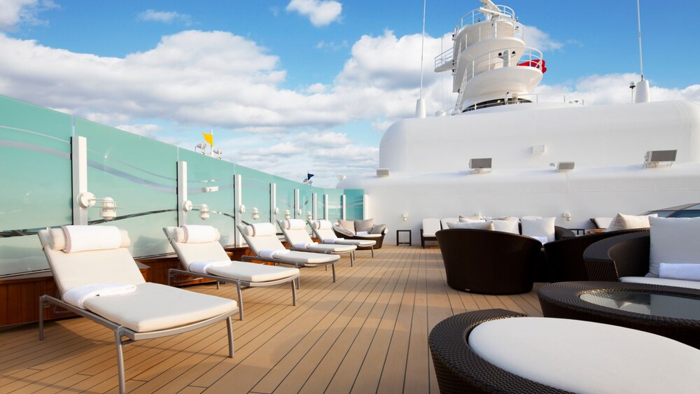 The Concierge Lounge on a Disney cruise ship featuring lounge chairs, sofas and tables