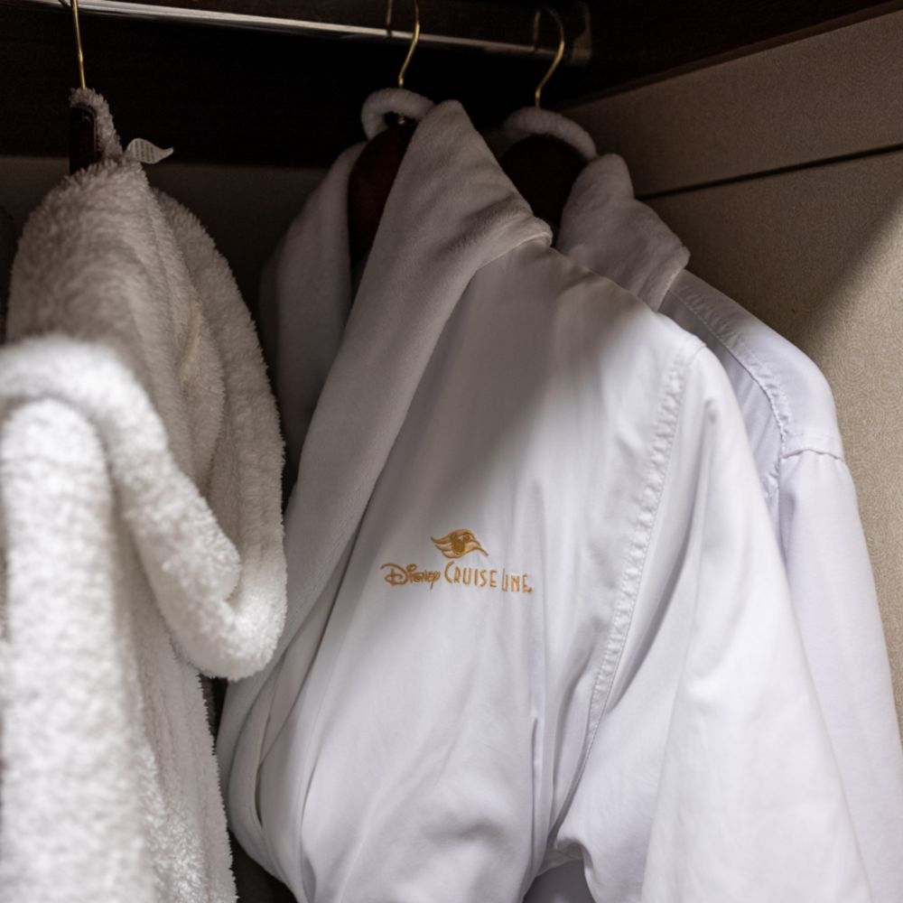Disney Cruise Line bathrobes hanging in a closet