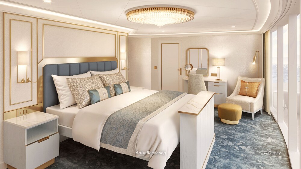 A Disney Wish Concierge One Story Royal Suite with Verandah bedroom featuring a bed, vanity, chair, 2 nightstands and a verandah