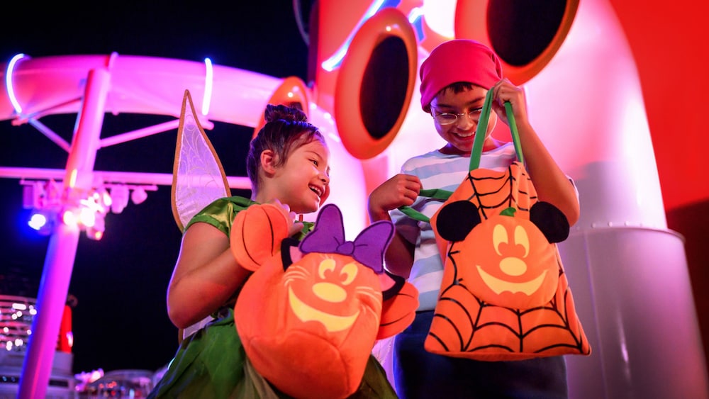 Two children dressed as Tinker Bell and Mister Smee enjoying Halloween on the High Seas aboard a Disney Cruise Line ship