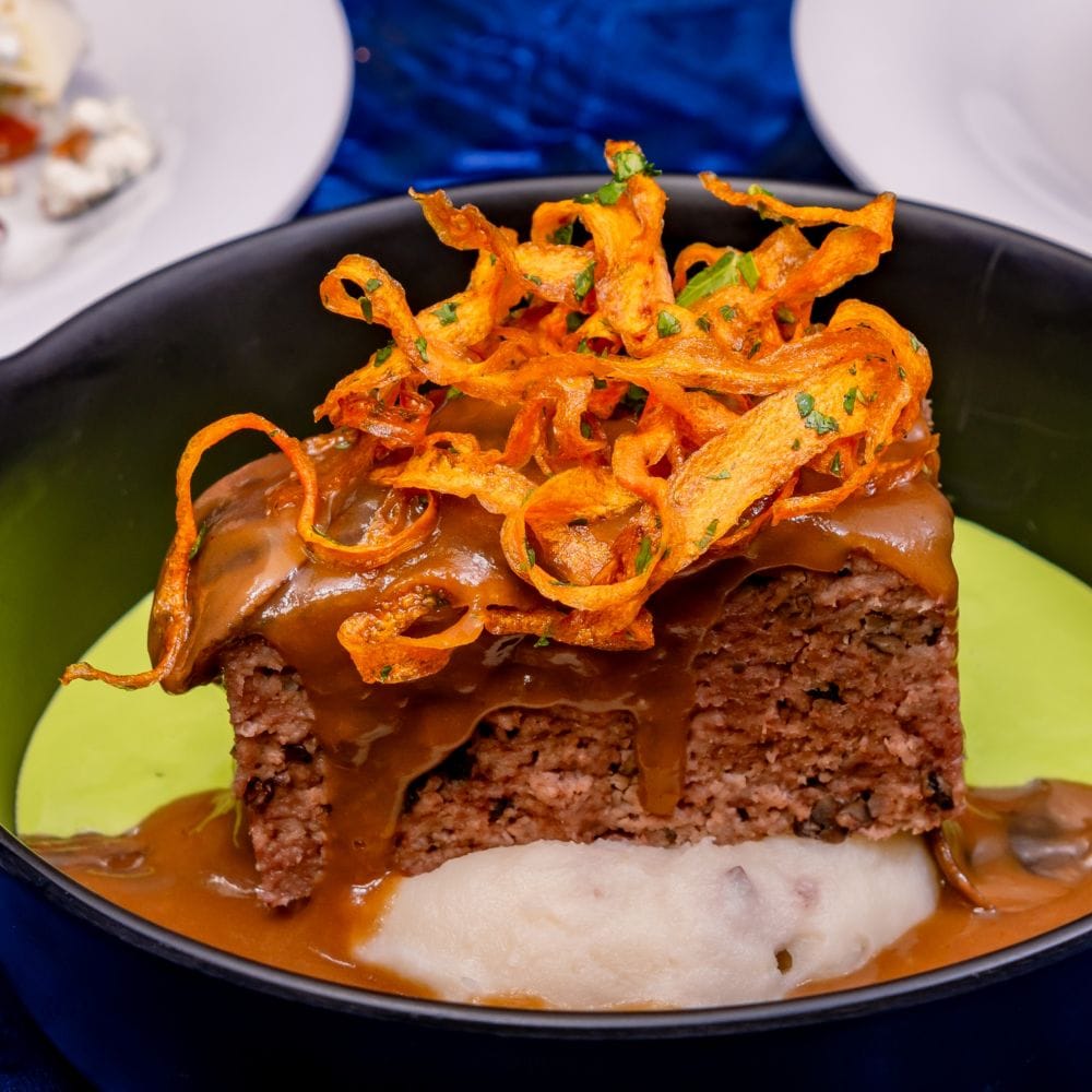 A baby wedge salad, mushroom gravy glazed meatloaf and chocolate cake dessert, all part of the Plaza Inn Paint the Night Dining Package