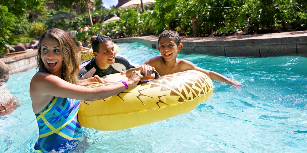 At the Waikolohe Stream, a couple and their son hold onto a raft