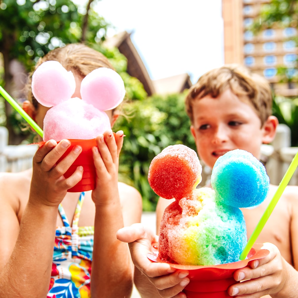 Two children hold their Papalua Shave Ice, shaped to resemble Mickey Mouse’s head