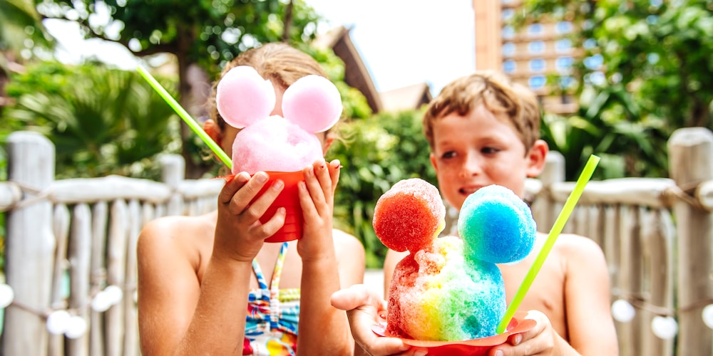 Two children hold their Papalua Shave Ice, shaped to resemble Mickey Mouse’s head