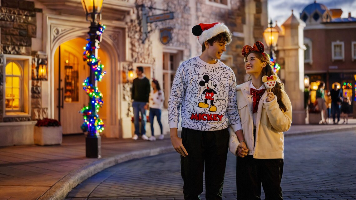 A couple strolling down Main Street, USA during Holidays at Walt Disney World Resort