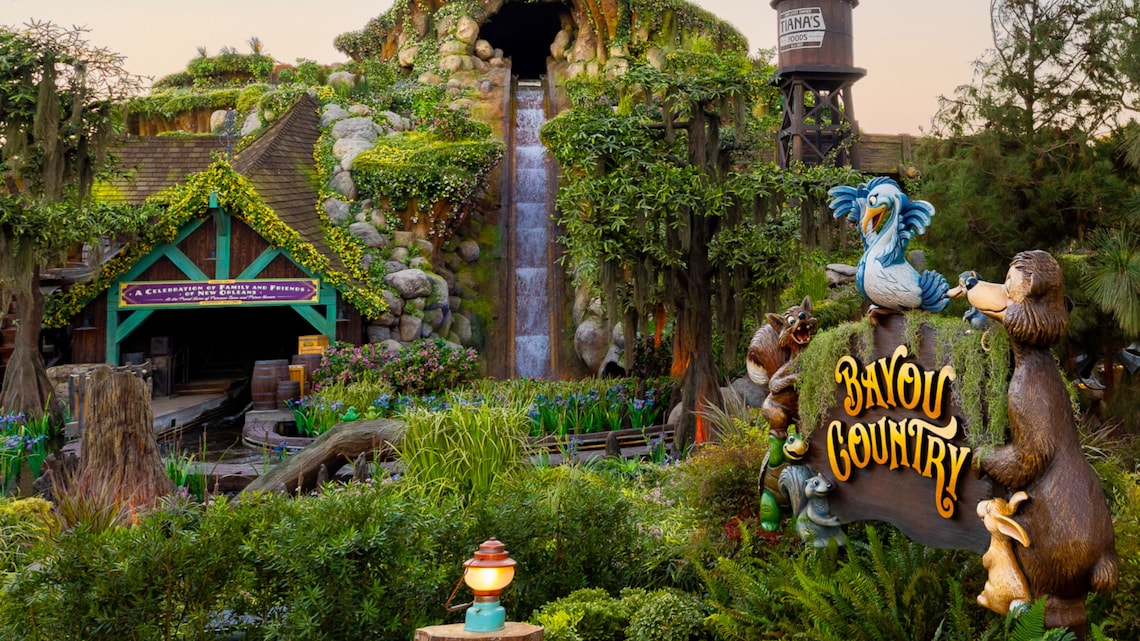 The big drop at Tiana's Bayou Adventure and a sign that reads 'Bayou Country' surrounded by lush vegetation