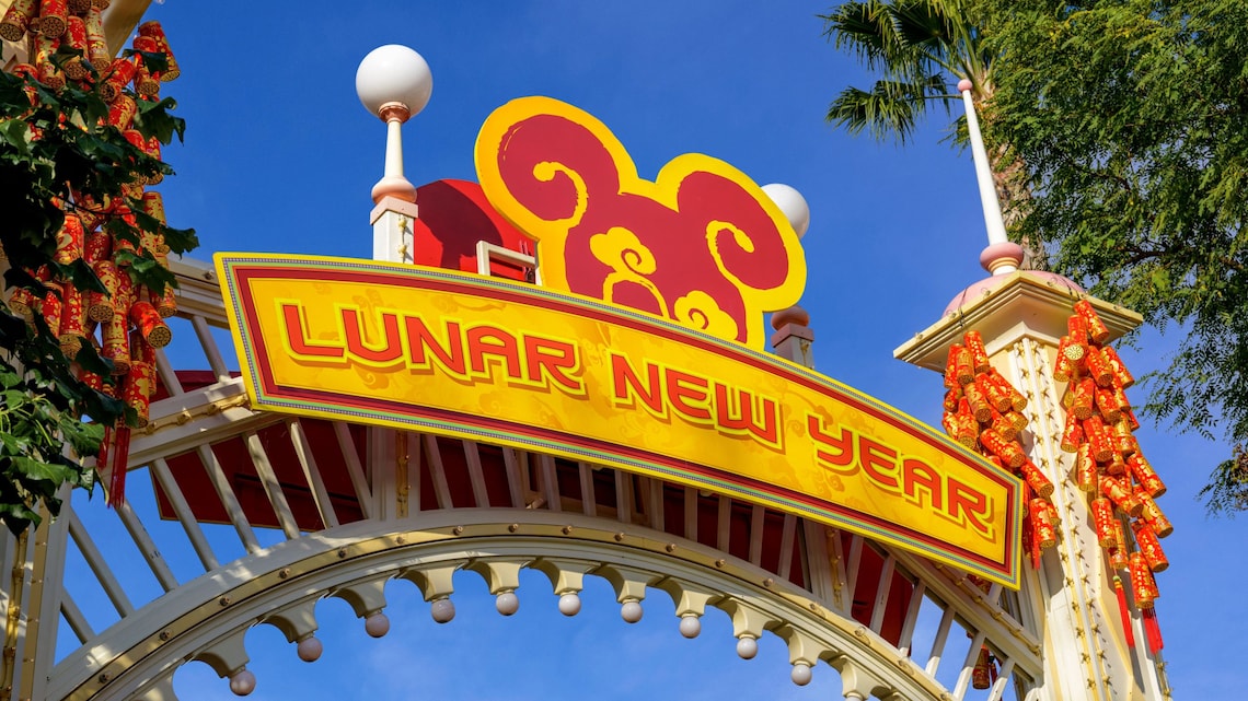 A sign reading Lunar New Year, featuring a Mickey Mouse logo