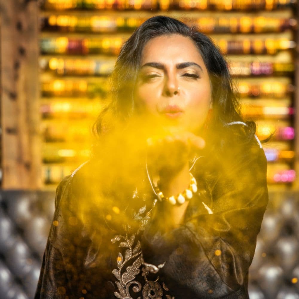 Enjoy authentic Indian cuisine from Chef Maneet Chauhan and her partner, Vivek Deora. slide 17 of 4 A woman near a wall decorated with bangles