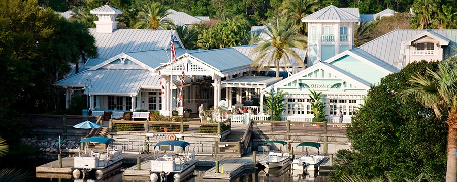 4 boats docked in the waters near the gabled exterior of Disney's Old Key West Resort
