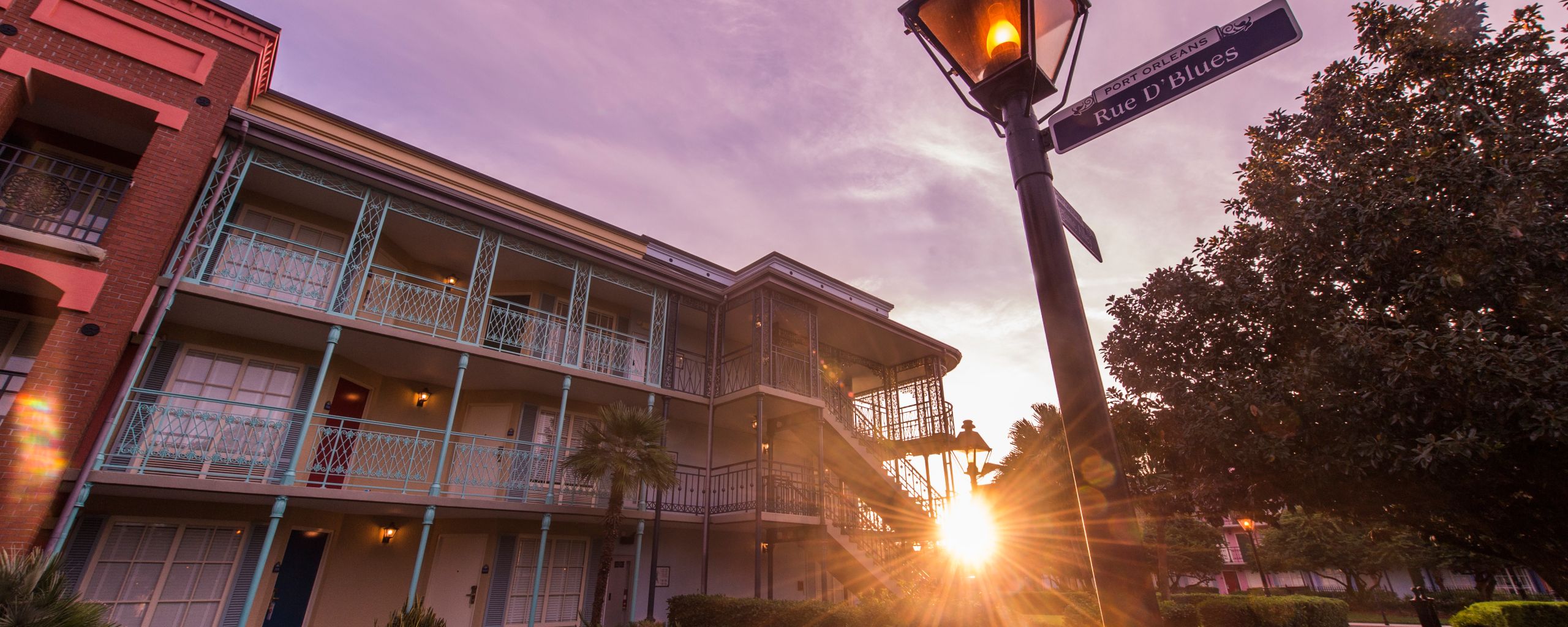 A courtyard at Disney's Port Orleans Resort with colorful buildings and lush landscaping