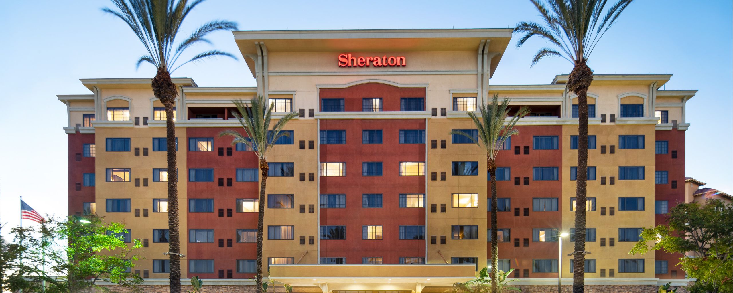 The outside of the Sheraton Garden Grove, Anaheim South Hotel at dusk