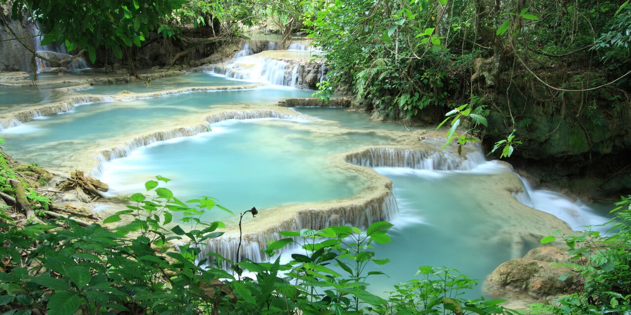 A waterfall tumbles down a hillside A waterfall tumbles down a hillside