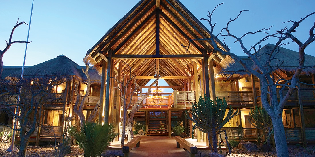 The impressive arched entrance to the Kapama River Lodge at twilight The impressive arched entrance to the Kapama River Lodge at twilight