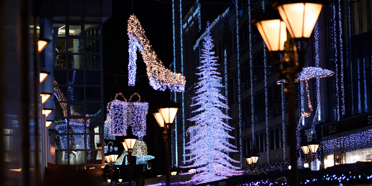 Buildings and trees in Budapest are decorated with holiday lights, including one shaped like a stiletto shoe and one shaped like a wrapped gift Buildings and trees in Budapest are decorated with holiday lights, including one shaped like a stiletto shoe and one shaped like a wrapped gift