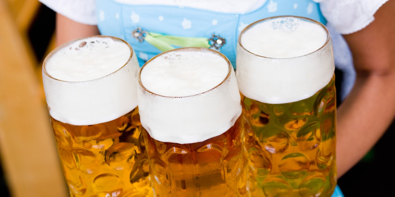 3 glass steins of beer on a tray 3 glass steins of beer on a tray