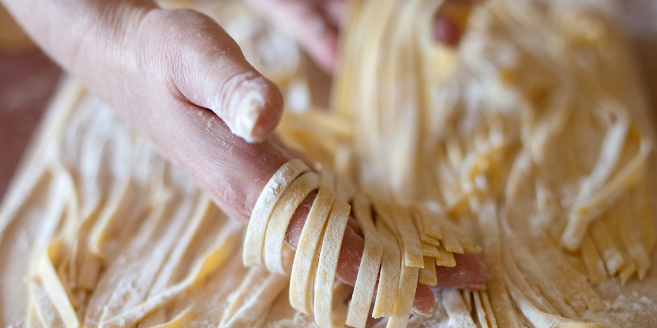 A woman makes pasta from scratch A woman makes pasta from scratch