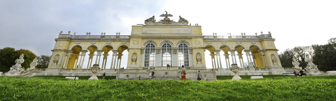 Looking up at Schönbrunn Palace from the bottom of a grassy hill Looking up at Schönbrunn Palace from the bottom of a grassy hill
