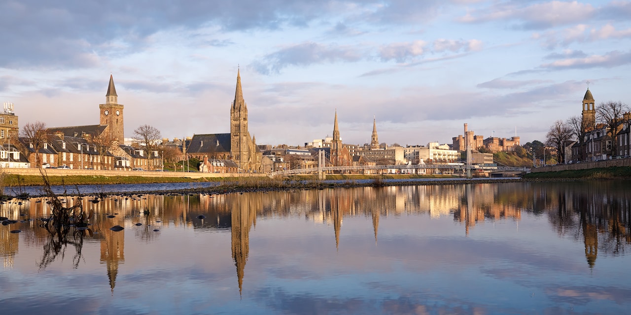 The city of Inverness, with steepled buildings reflected on the water of the River Ness The city of Inverness, with steepled buildings reflected on the water of the River Ness