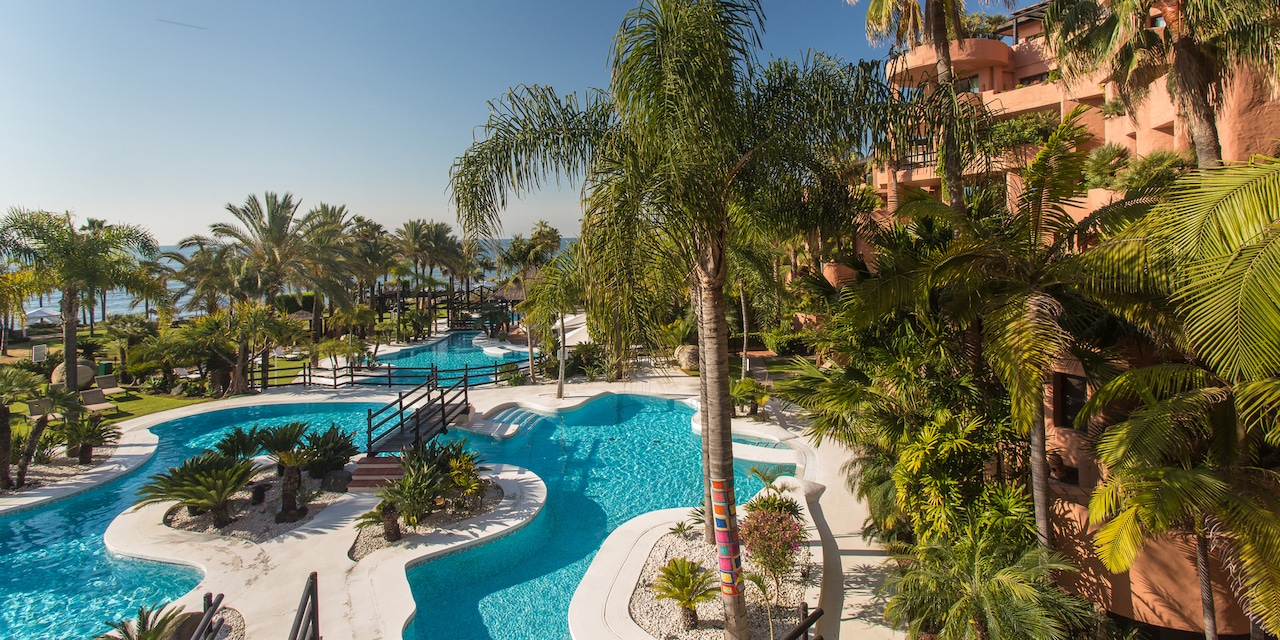 The Kempinski Hotel Bahía overlooks the pool area with its island feature and lush fauna The Kempinski Hotel Bahía overlooks the pool area with its island feature and lush fauna