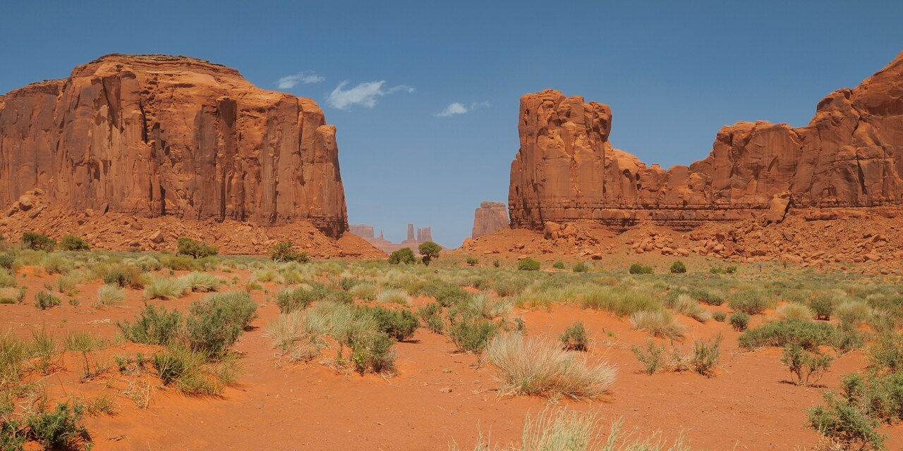 Buttes and mesas rise from a desert floor Buttes and mesas rise from a desert floor