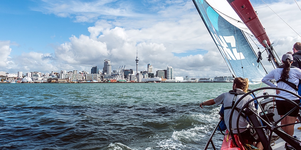 Sail boats sail in the harbor across from the Auckland, New Zealand sky line Sail boats sail in the harbor across from the Auckland, New Zealand sky line